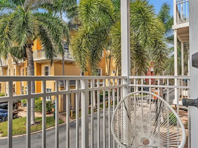 a white toilet sitting next to a white wall