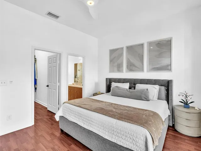 a bathroom with a granite countertop sink a mirror and shower