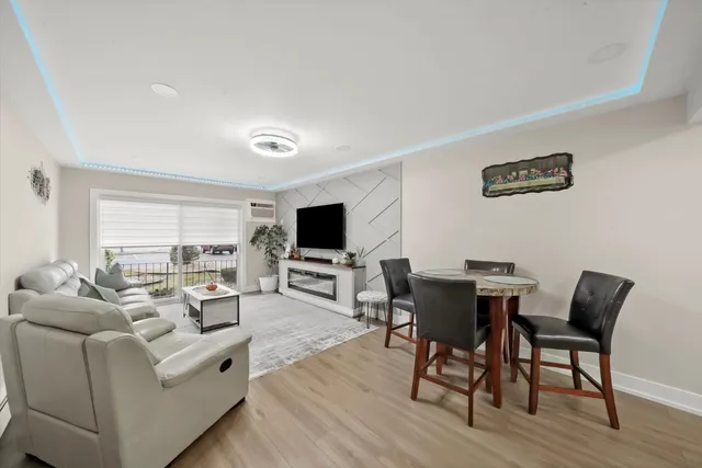 a living room with furniture a flat screen tv and a large window