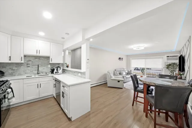 a kitchen with stainless steel appliances a refrigerator sink and microwave
