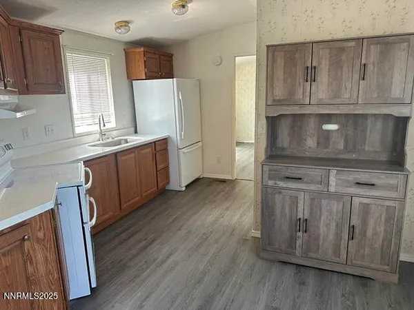 a kitchen with a refrigerator sink and stove
