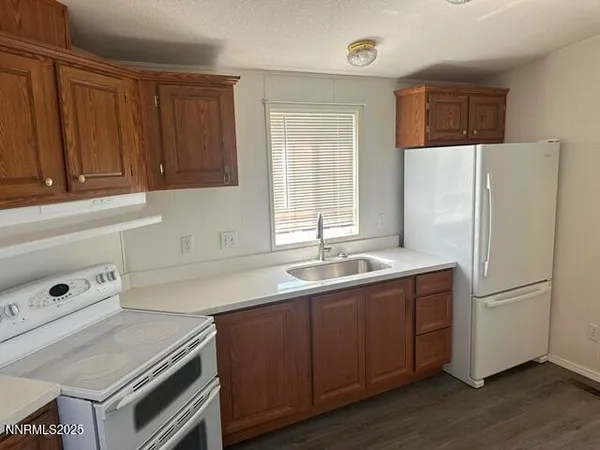 a kitchen with wooden floors and wooden cabinets