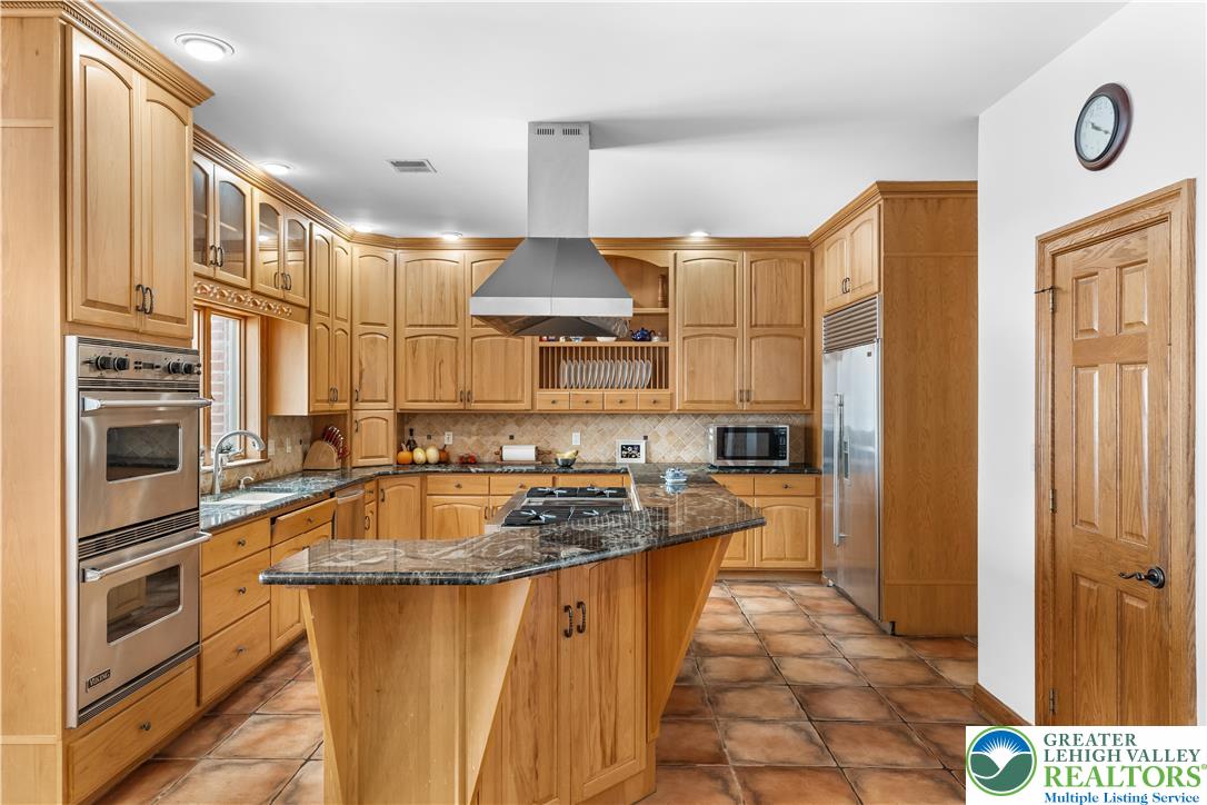 216 Merwinsburg Road Effort, PA 18330 - Photo 14 of 50 a kitchen with stainless steel appliances granite countertop a sink a stove and a refrigerator