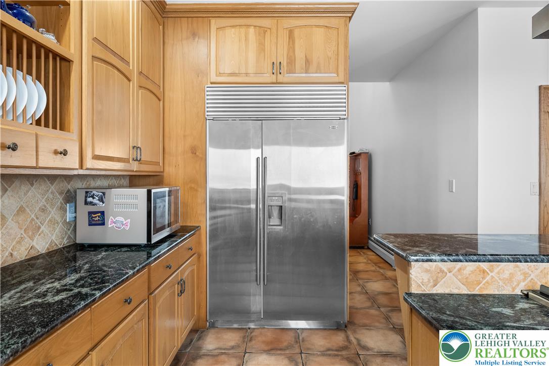 216 Merwinsburg Road Effort, PA 18330 - Photo 16 of 50 a kitchen with granite countertop a refrigerator and a stove