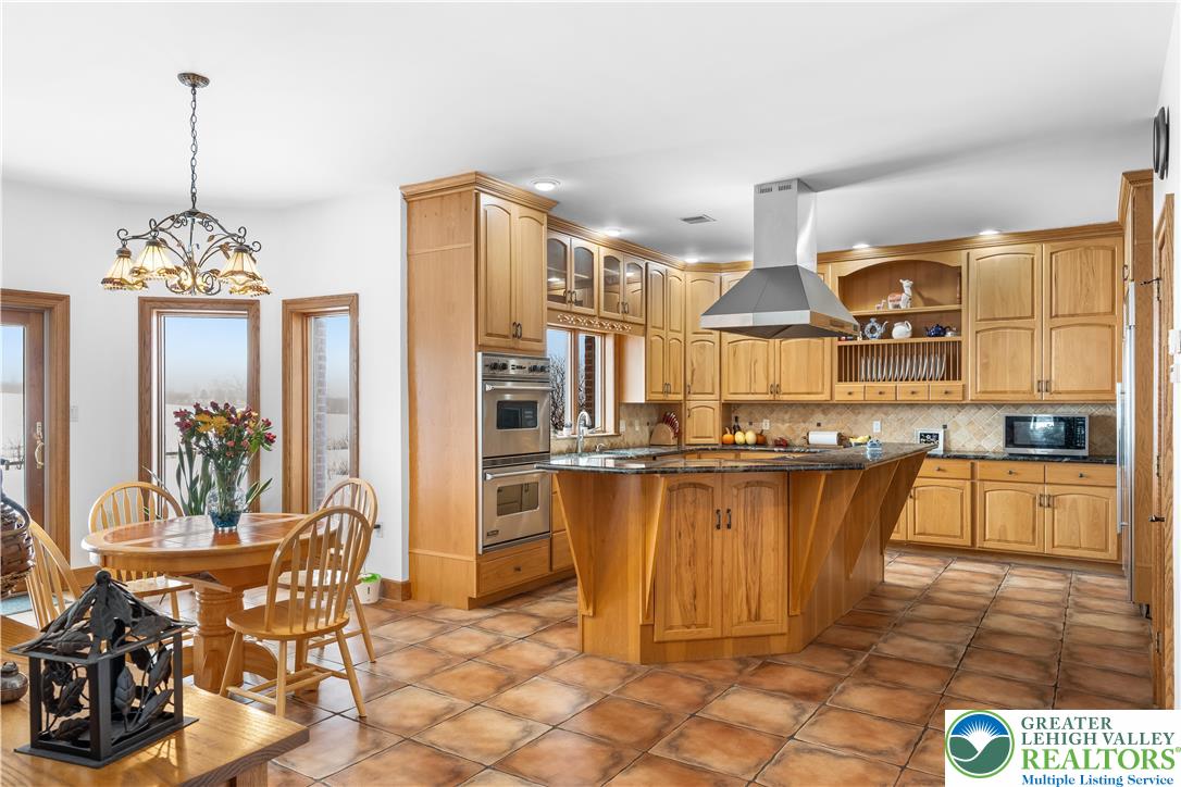 216 Merwinsburg Road Effort, PA 18330 - Photo 17 of 50 a dining table chairs next to a window and kitchen view