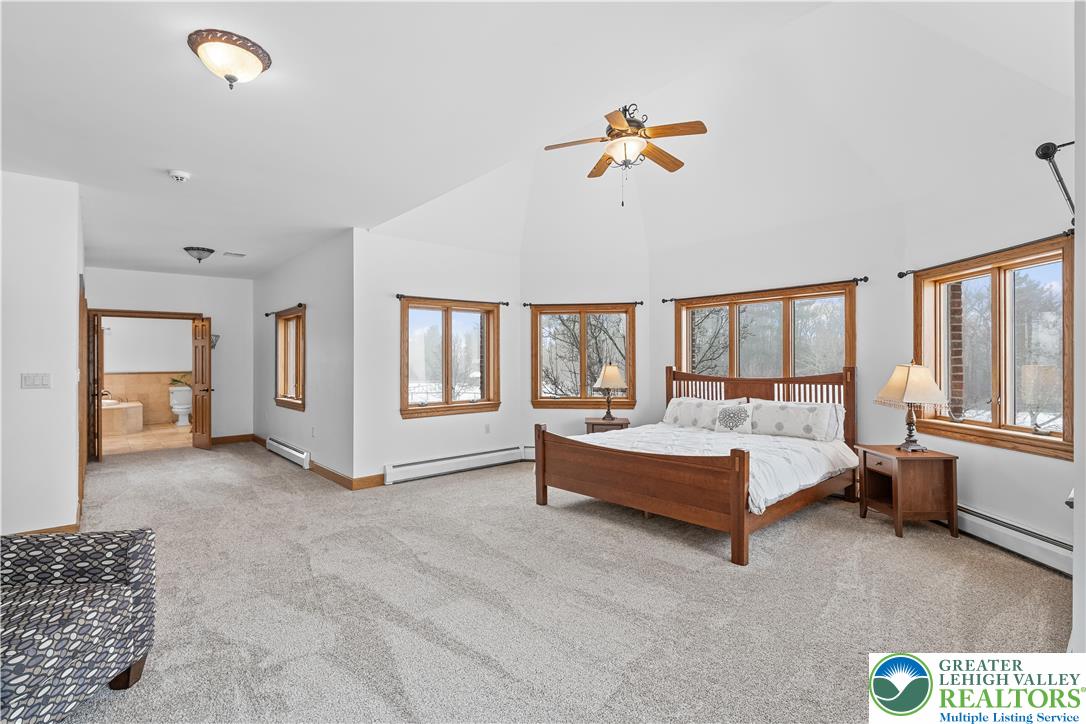 216 Merwinsburg Road Effort, PA 18330 - Photo 22 of 50 a spacious bedroom with a bed and a chandelier