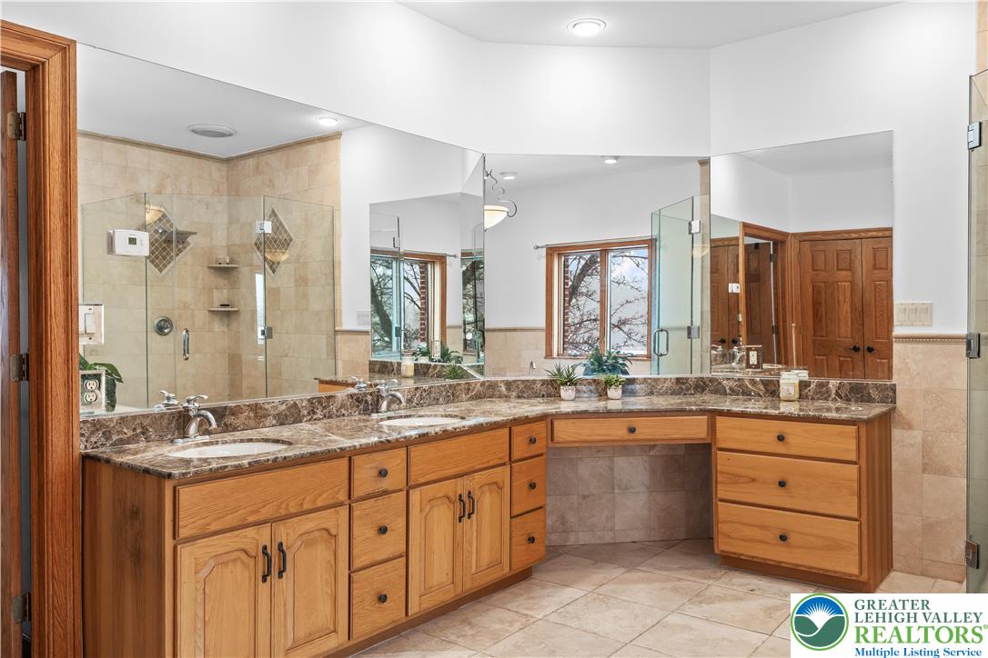 216 Merwinsburg Road Effort, PA 18330 - Photo 28 of 50 a bathroom with a granite countertop sink double and mirror