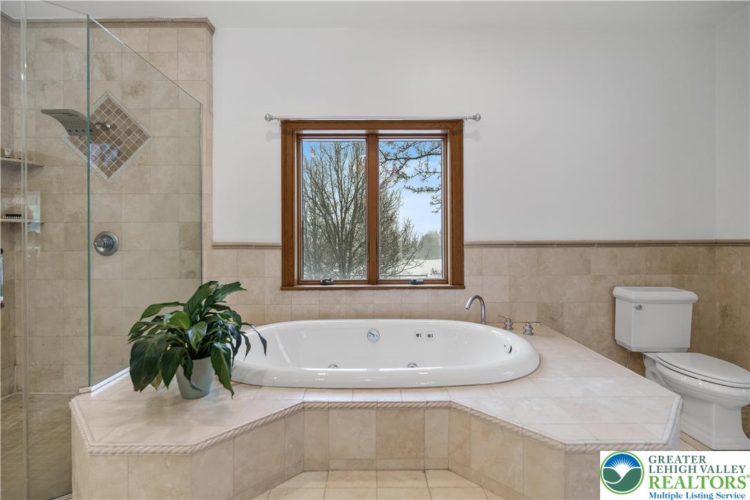216 Merwinsburg Road Effort, PA 18330 - Photo 29 of 50 a white bath tub sitting in a bathroom next to a window