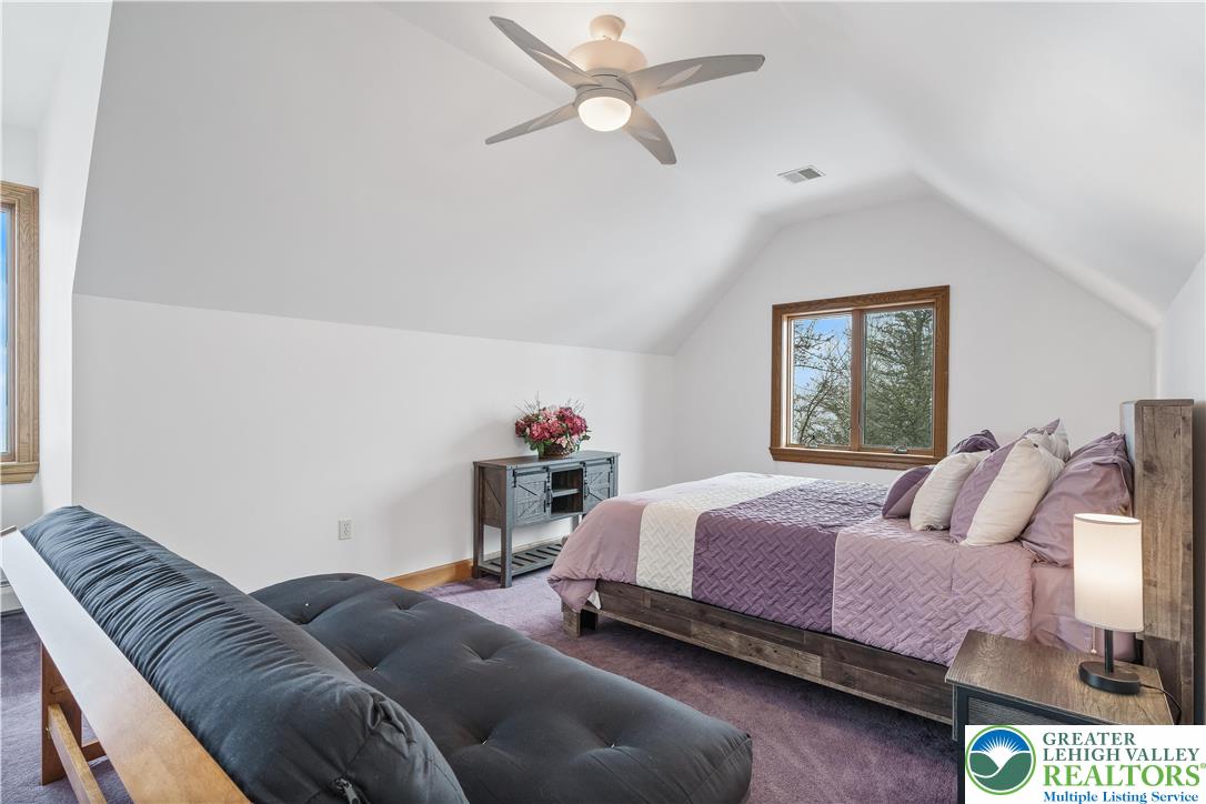 216 Merwinsburg Road Effort, PA 18330 - Photo 30 of 50 a bedroom with a bed and a chandelier fan