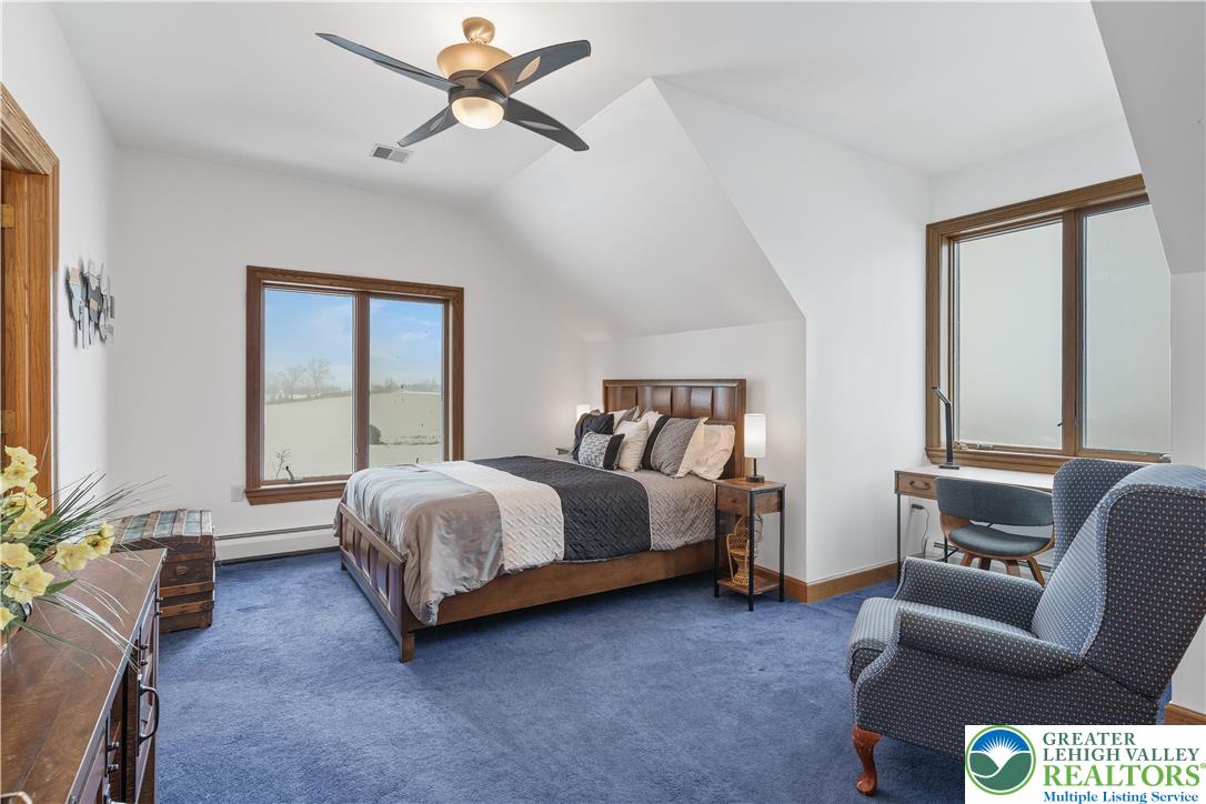 216 Merwinsburg Road Effort, PA 18330 - Photo 33 of 50 a spacious bedroom with a bed a couch and a window