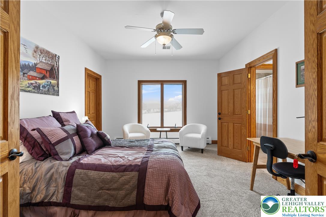 216 Merwinsburg Road Effort, PA 18330 - Photo 39 of 50 a bedroom with bed and large windows