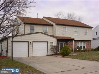 7 McIntosh Road Sewell, NJ 08080 - Photo 1 of 1 a front view of a house with a garden and garage