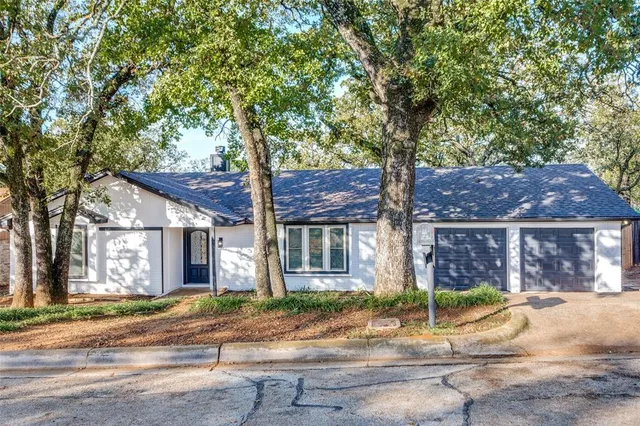 a front view of a house with a garden and plants