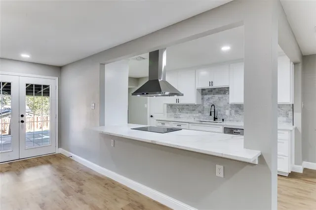 a kitchen with stainless steel appliances a sink and a refrigerator