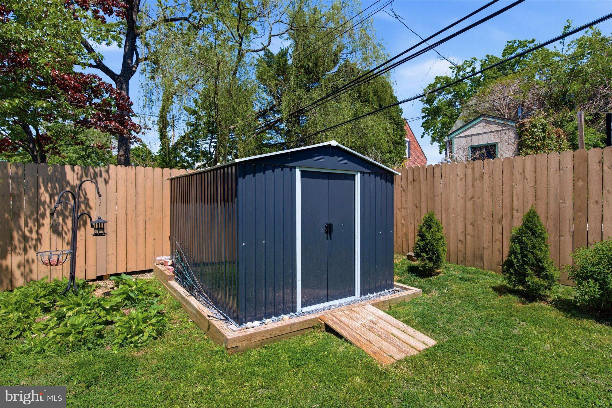 702 Hood Road Swarthmore, PA 19081 - Photo 31 of 35 Charming garden shed in lush greenery.