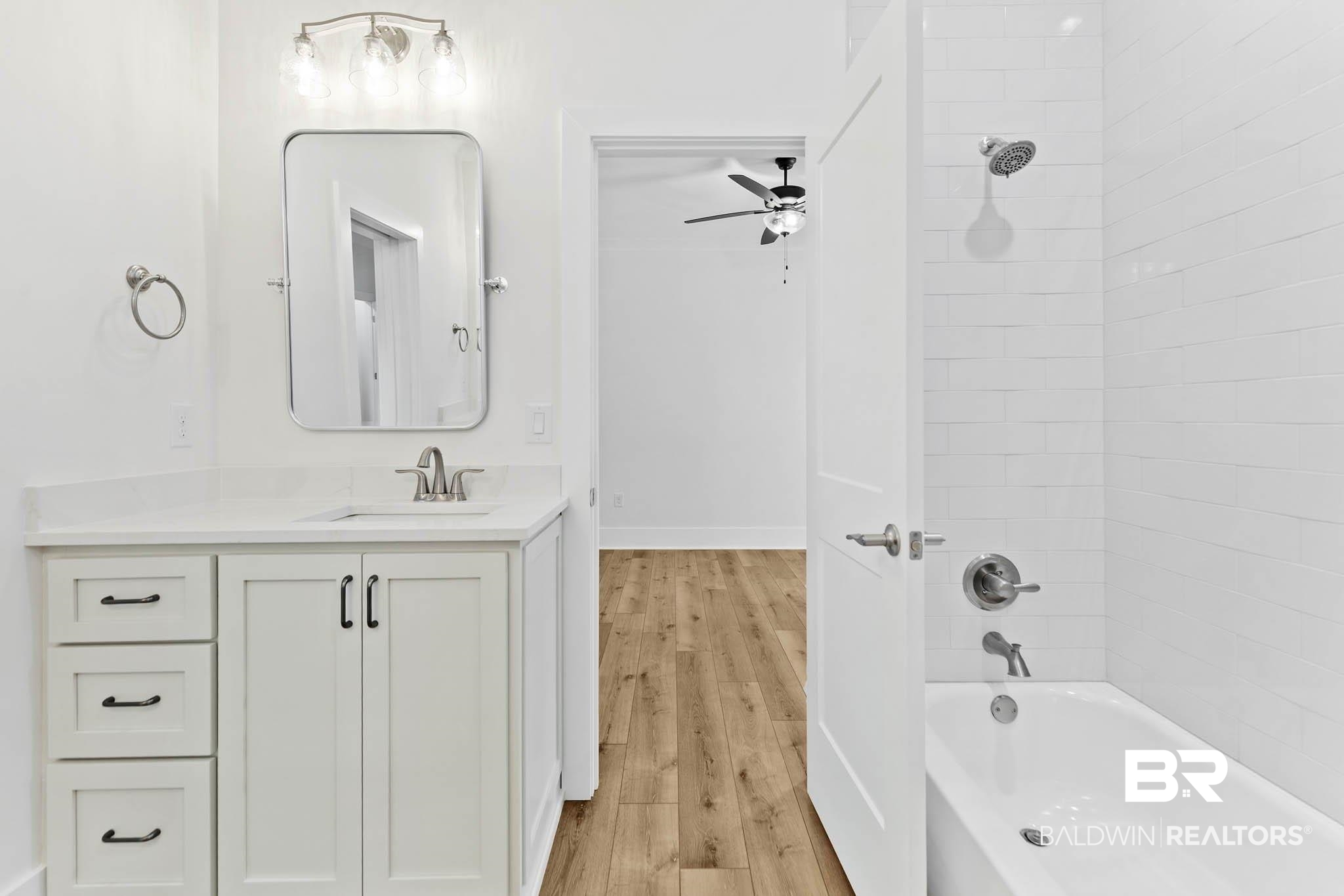 6656 Garrison Drive Daphne, AL 36527 - Photo 39 of 57 Full bath featuring vanity, shower / bathtub combination, light wood-style flooring, and a ceiling fan