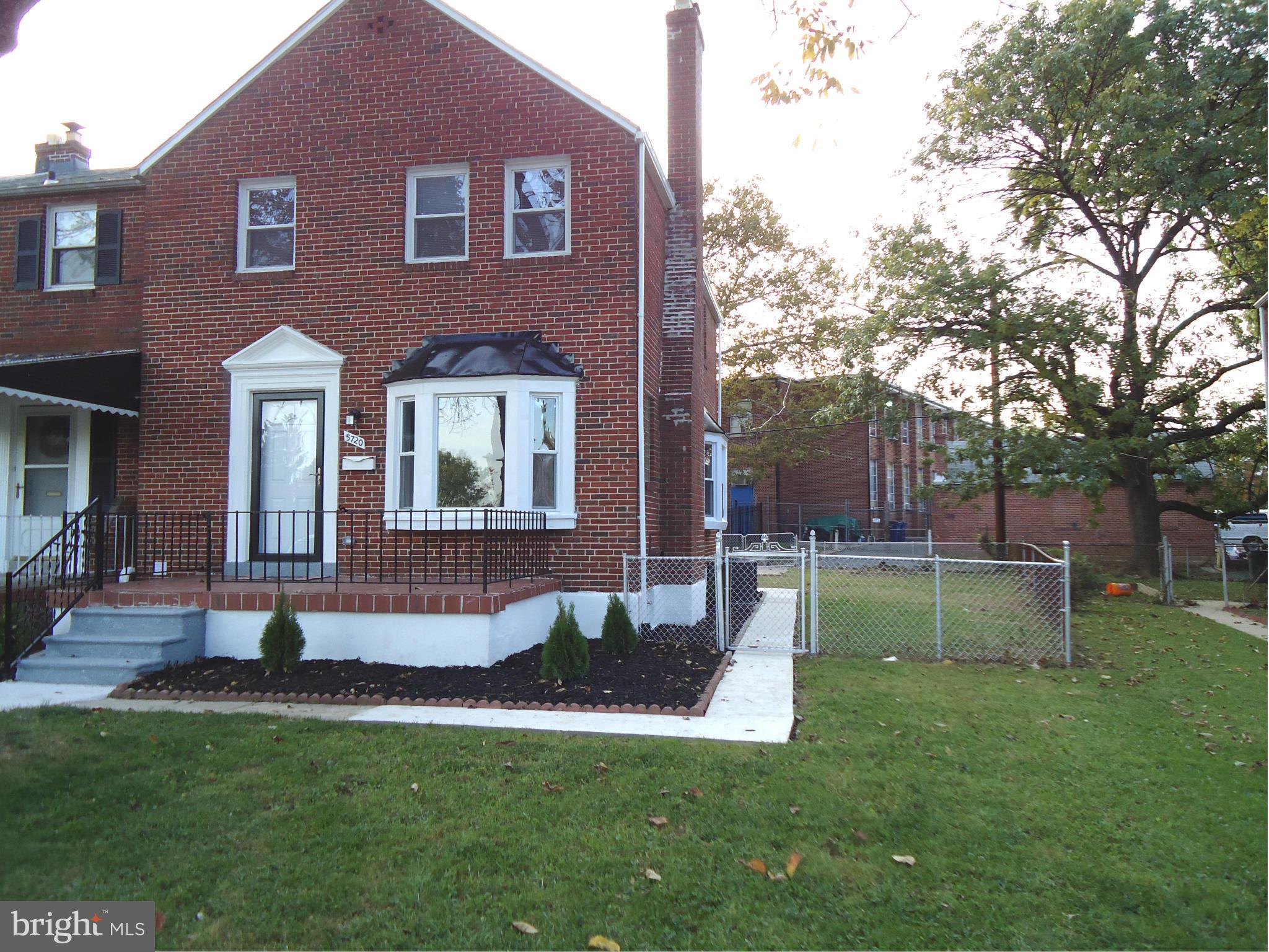5720 Maplehill Road Baltimore, MD 21239 - Photo 1 of 25 a front view of a house with a yard
