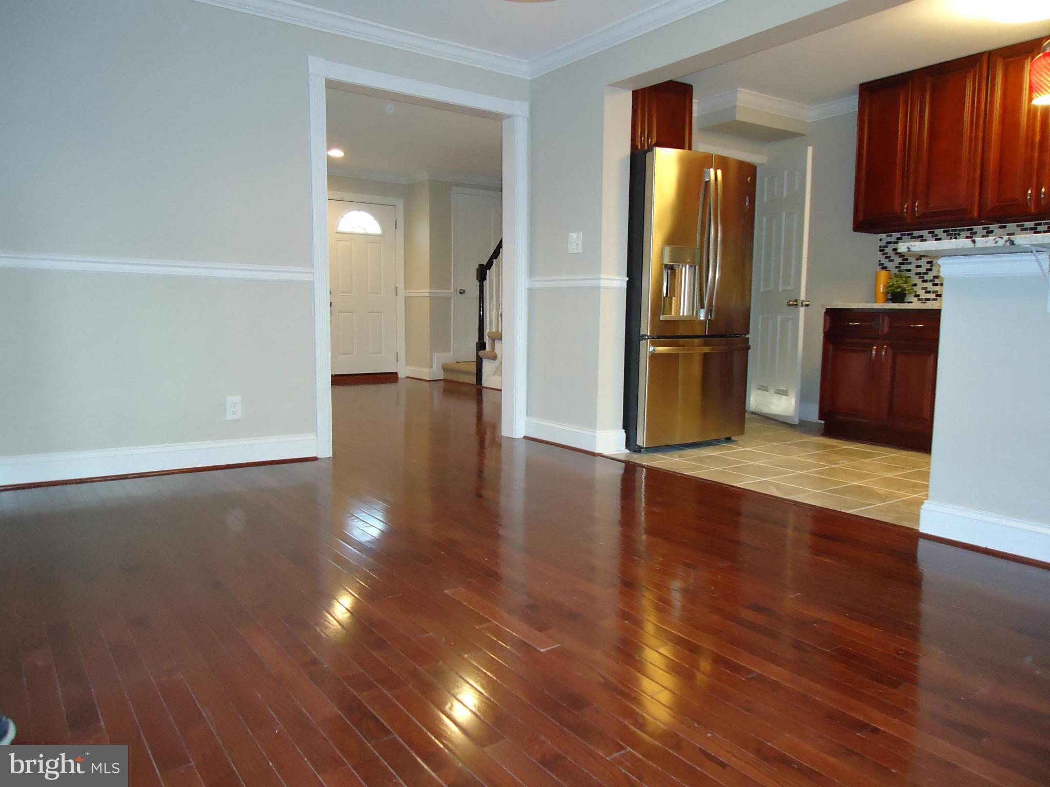 5720 Maplehill Road Baltimore, MD 21239 - Photo 12 of 25 a view of a kitchen with stainless steel appliances wooden floor and a view of kitchen