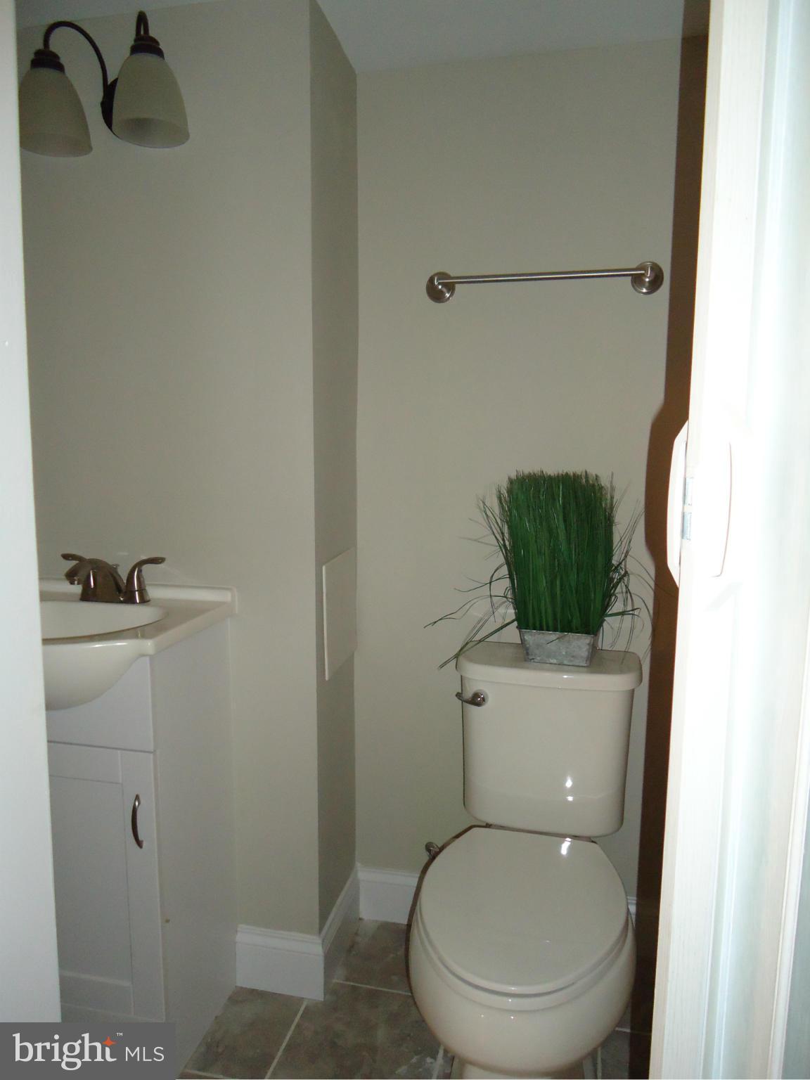 5720 Maplehill Road Baltimore, MD 21239 - Photo 13 of 25 a white toilet sitting next to a shower