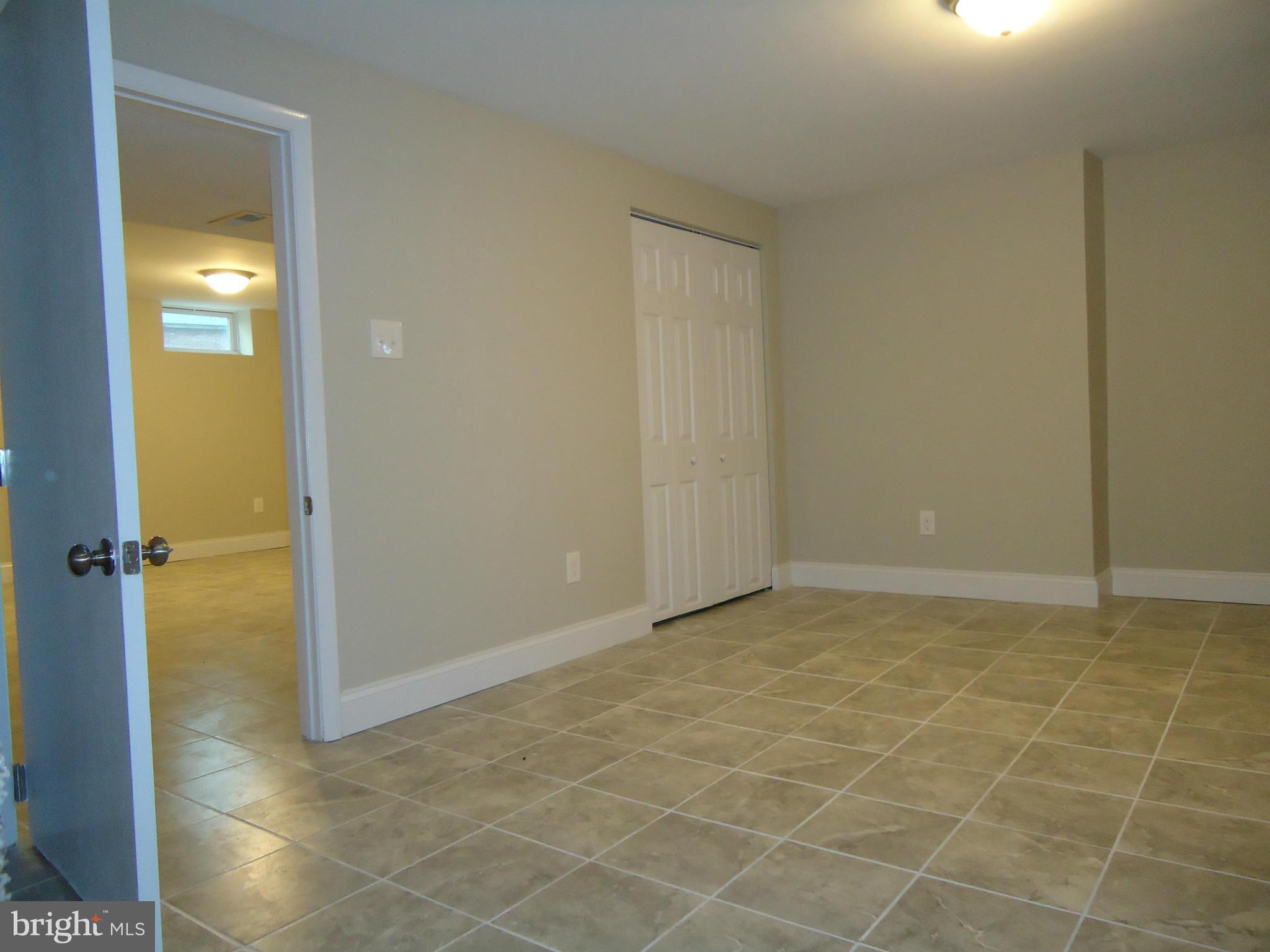 5720 Maplehill Road Baltimore, MD 21239 - Photo 14 of 25 an empty room with a bathroom
