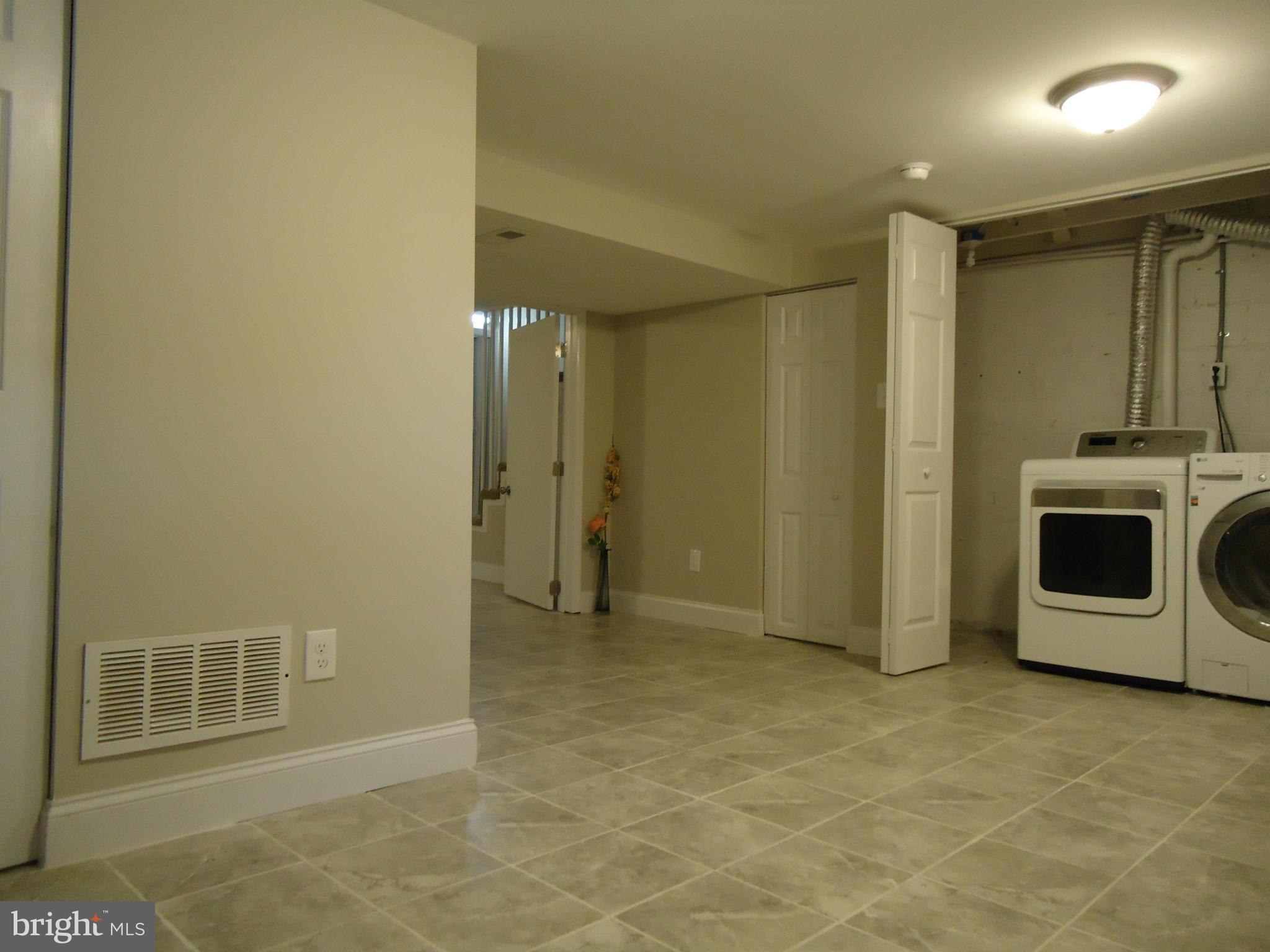 5720 Maplehill Road Baltimore, MD 21239 - Photo 17 of 25 a view of a storage & utility room with washer and dryer