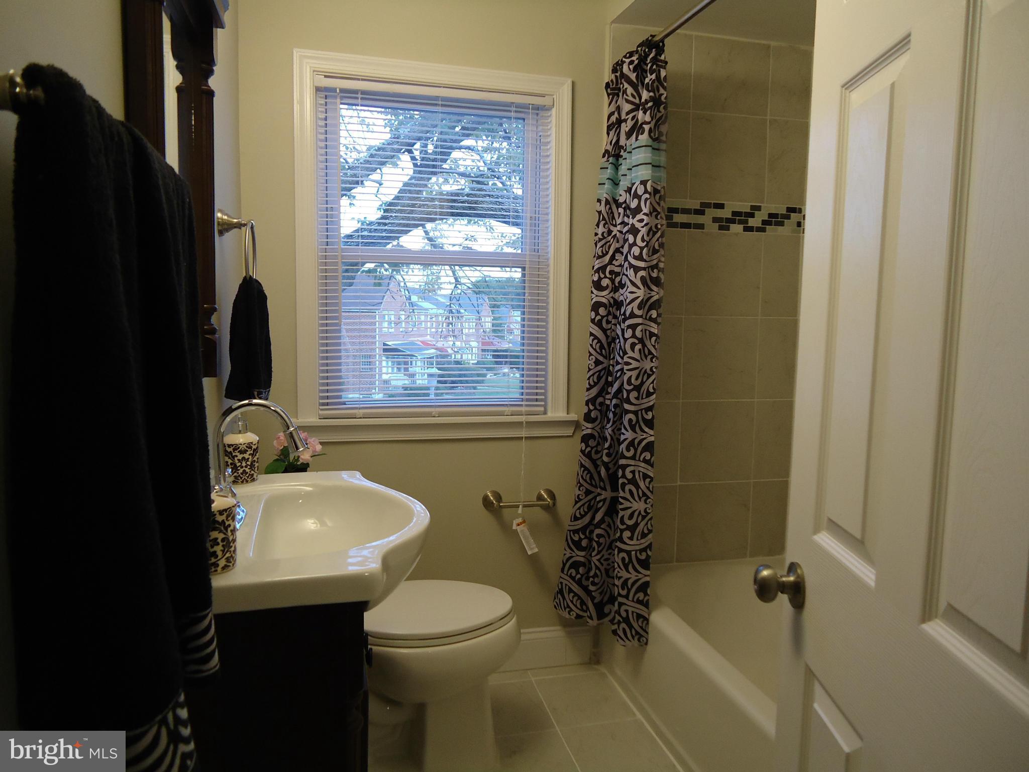5720 Maplehill Road Baltimore, MD 21239 - Photo 21 of 25 a bathroom with a sink toilet and shower
