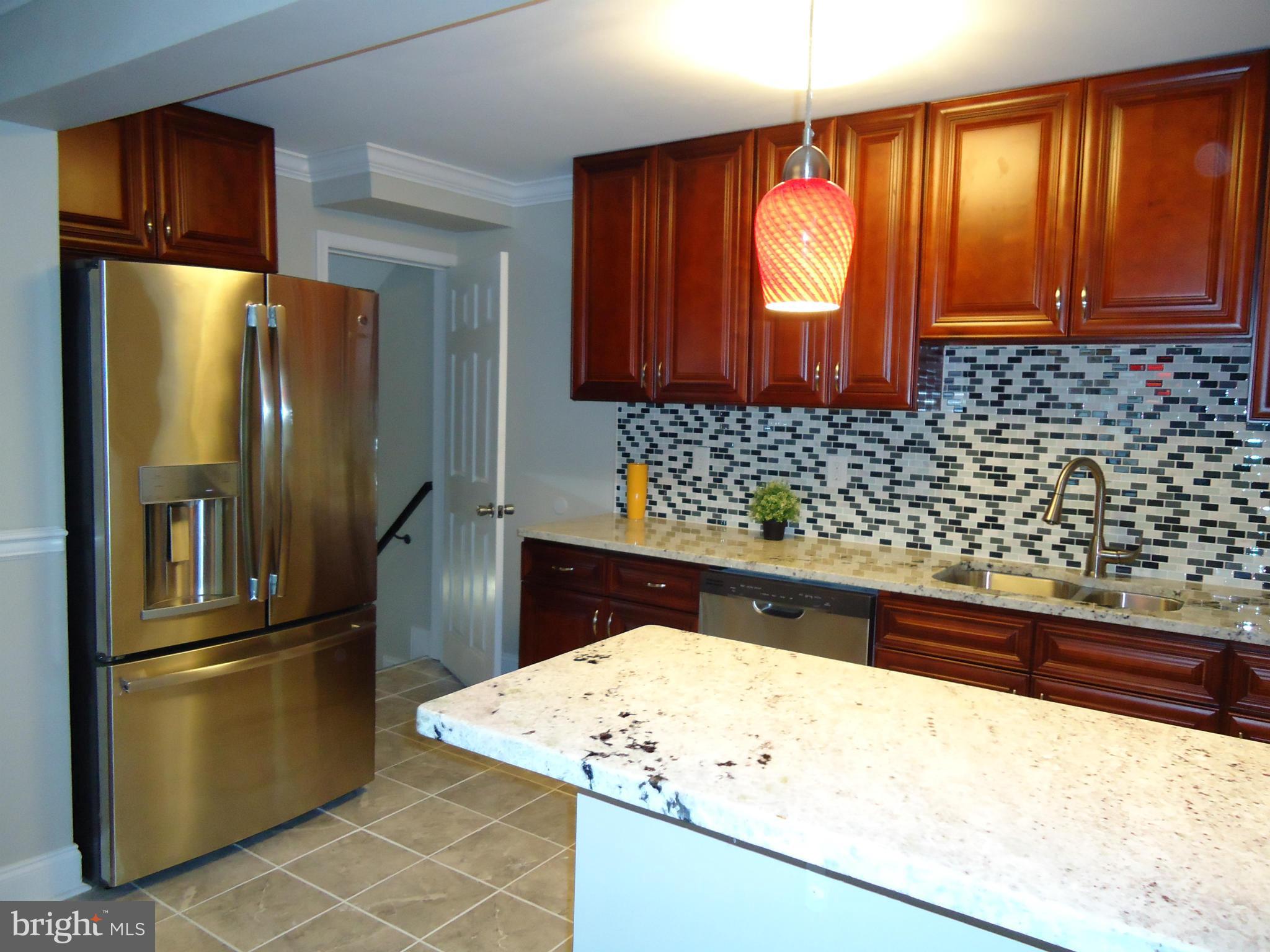 5720 Maplehill Road Baltimore, MD 21239 - Photo 8 of 25 a kitchen with granite countertop a refrigerator and a sink