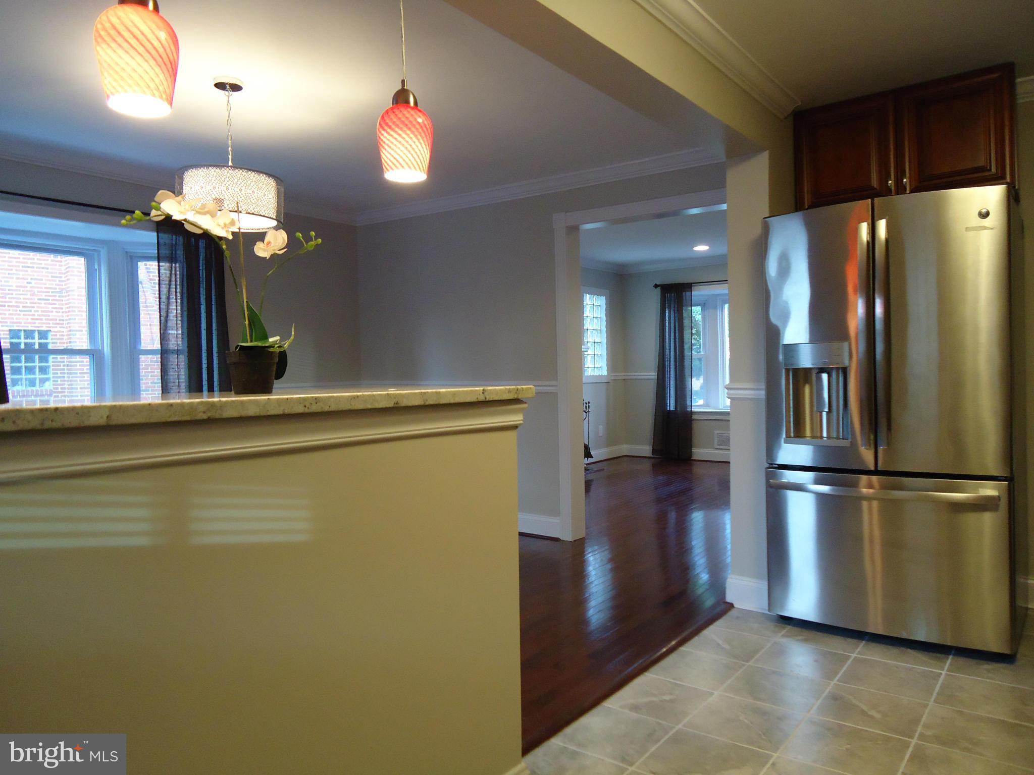5720 Maplehill Road Baltimore, MD 21239 - Photo 10 of 25 a kitchen with stainless steel appliances granite countertop a refrigerator a sink and a stove