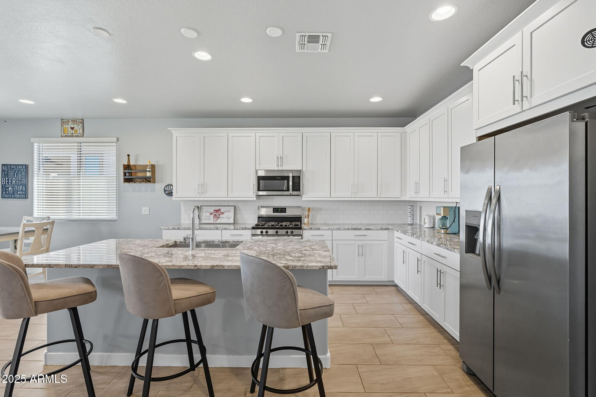 12404 East Soloman Road Gold Canyon, AZ 85118 - Photo 14 of 47 a kitchen with stainless steel appliances kitchen island granite countertop a refrigerator a stove a sink and white cabinets with wooden floor