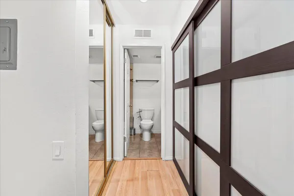 a view of a hallway with wooden floor and staircase