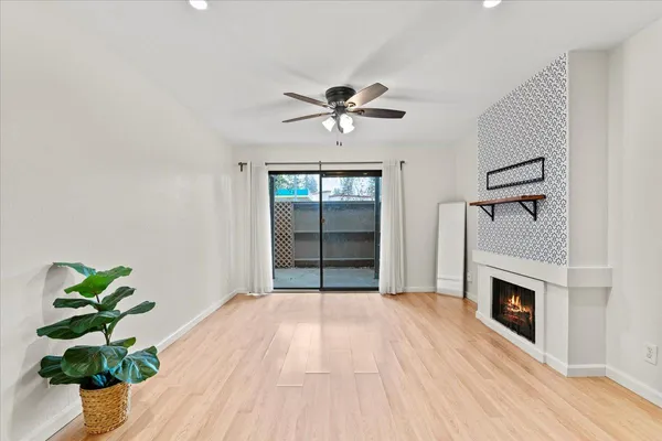 a view of an empty room with a fireplace and a potted plant