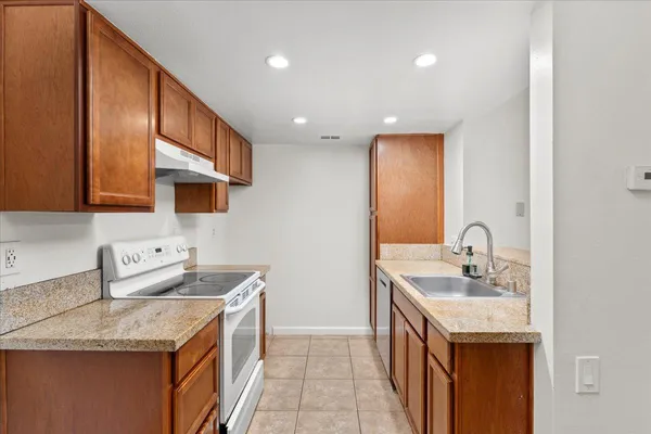 a kitchen with a sink stove and cabinets