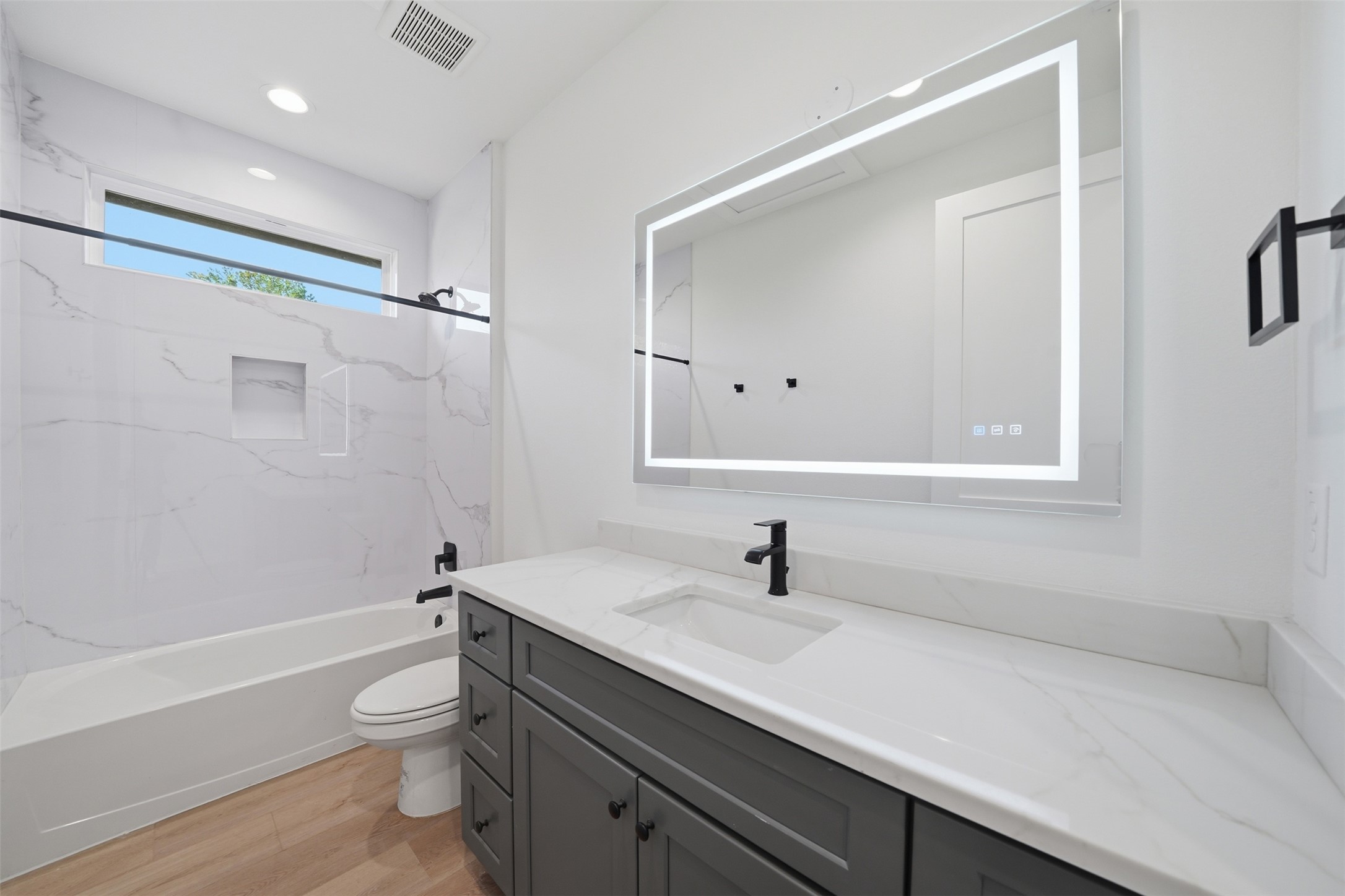 2212 Yellow Jacket Lane, Unit 2 Austin, TX 78741 - Photo 19 of 25 Bathroom featuring a gray vanity with shaker-style cabinetry, a white countertop, and a rectangular undermount sink