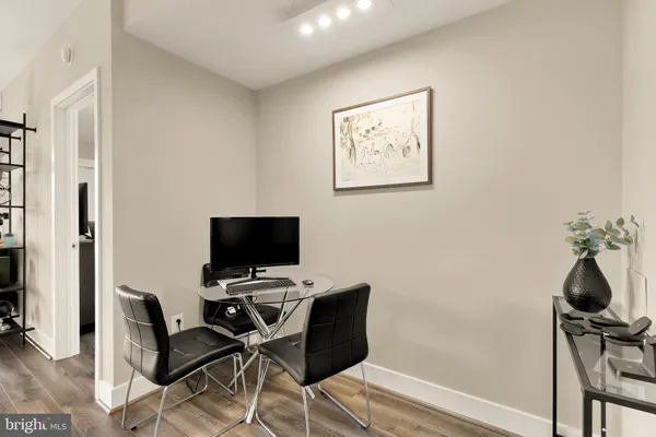 a view of a workspace with furniture and a window