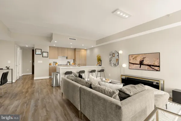 a living room with furniture and kitchen view