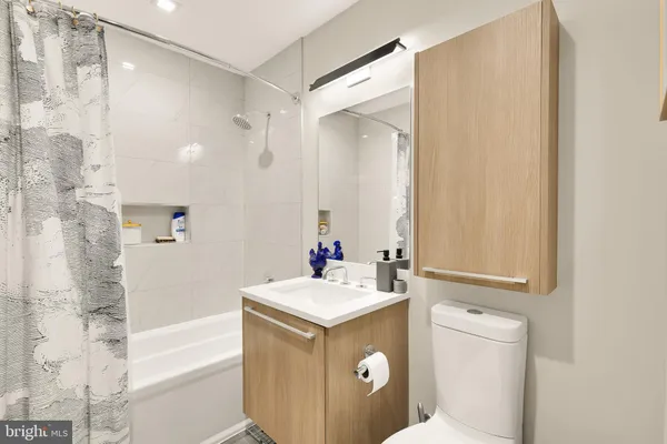 a bathroom with a sink toilet vanity and tub