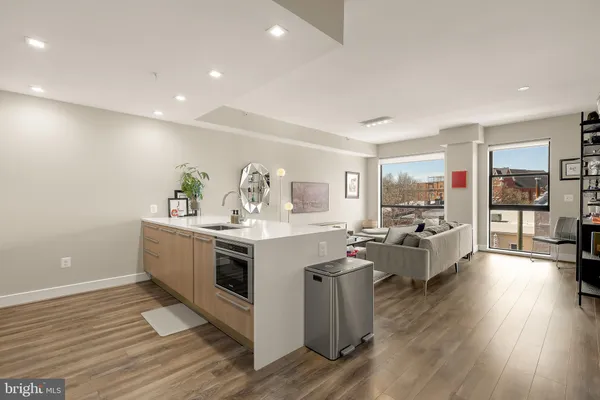 a view of living room with furniture and wooden floor