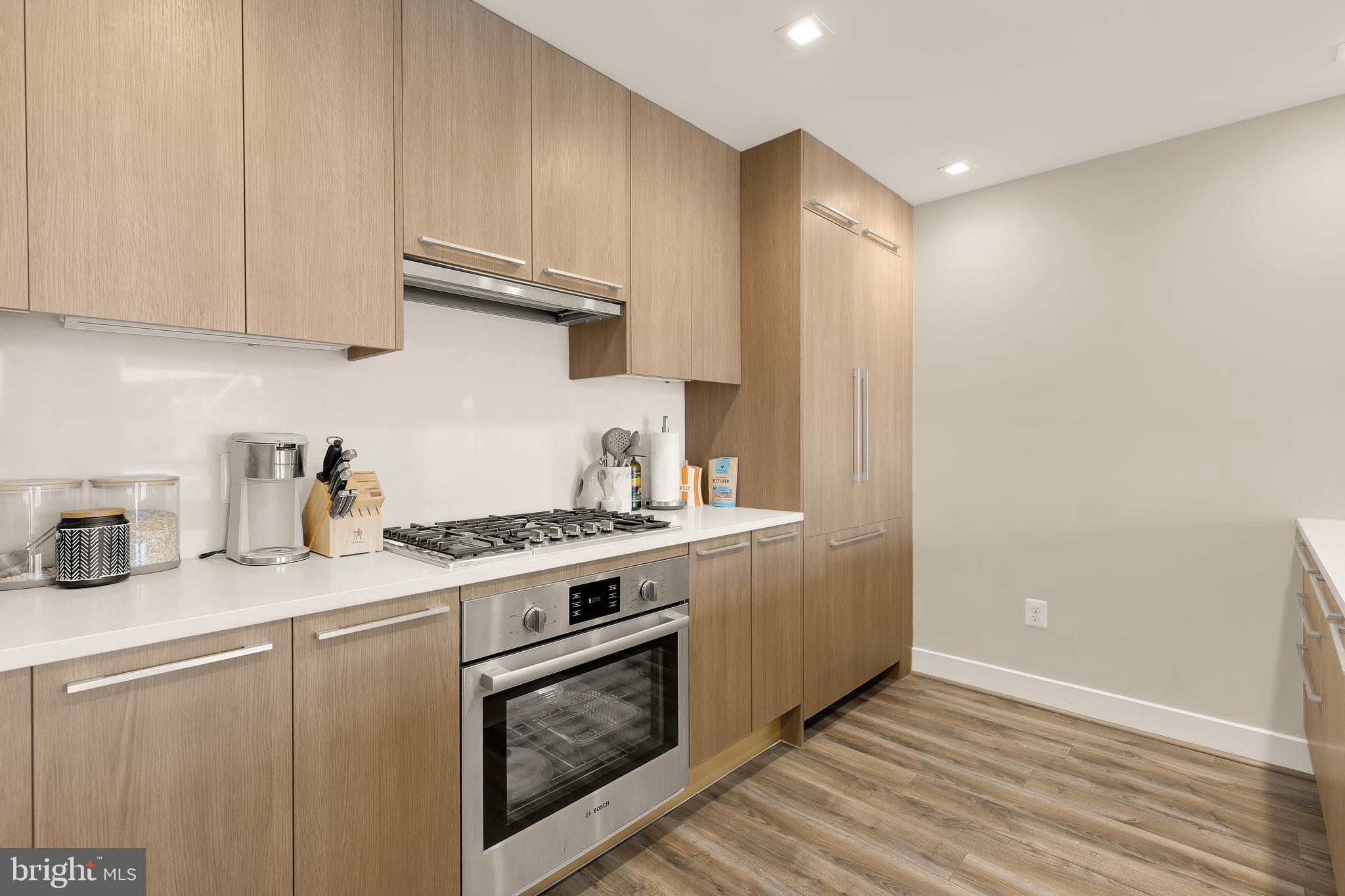 1628 11th Street Northwest, Unit 308 Washington, DC 20001 - Photo 4 of 26 a kitchen with granite countertop a stove sink and cabinets