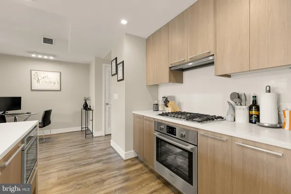a kitchen with stainless steel appliances granite countertop a stove and a refrigerator