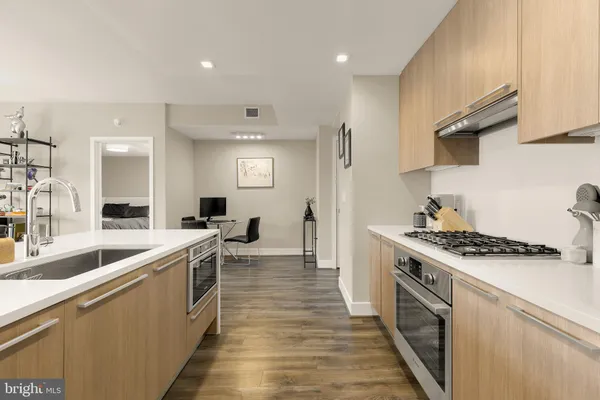 a kitchen with a sink a stove and chairs