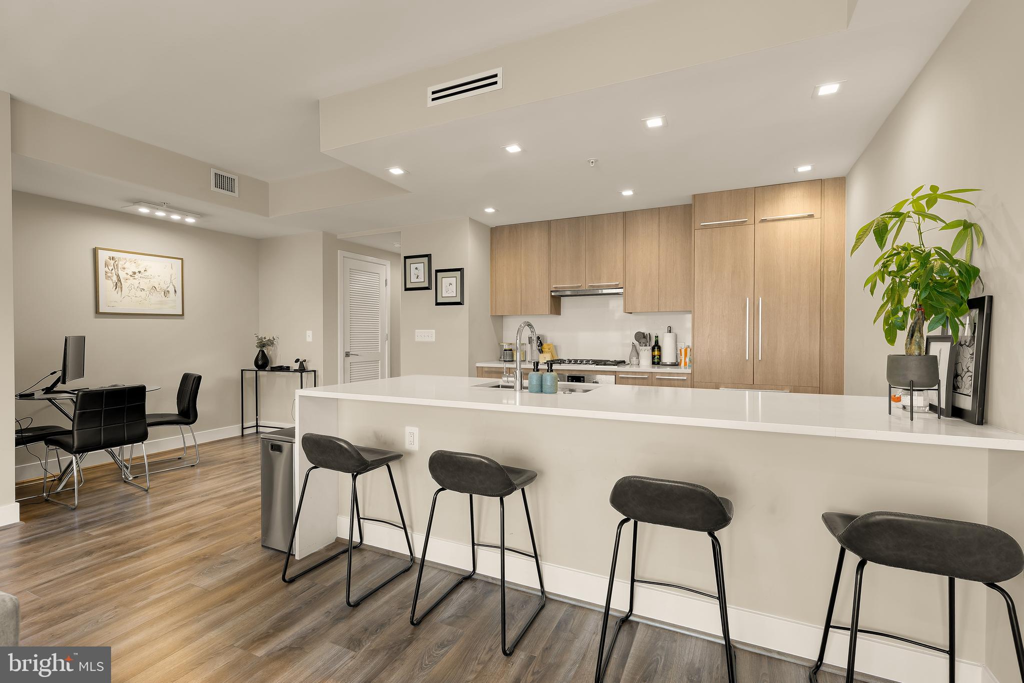1628 11th Street Northwest, Unit 308 Washington, DC 20001 - Photo 10 of 26 a kitchen with stainless steel appliances granite countertop a refrigerator and a dining table