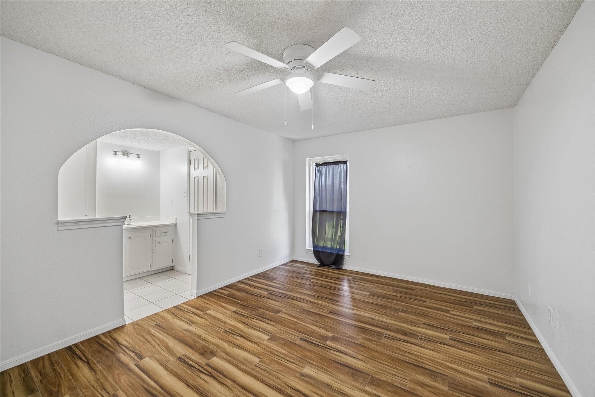 631 Lexington Square Humble, TX 77338 - Photo 11 of 22 Step into the serene primary bedroom, featuring elegant wood tile flooring that perfectly combines warmth and modern style.
