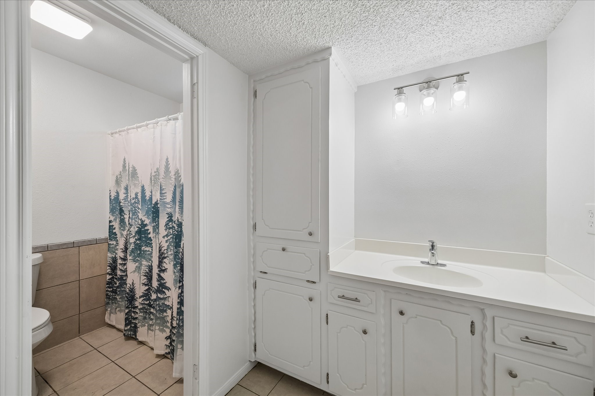 631 Lexington Square Humble, TX 77338 - Photo 12 of 22 This inviting primary bath features stylishly updated vanities, creating a fresh and modern retreat.
