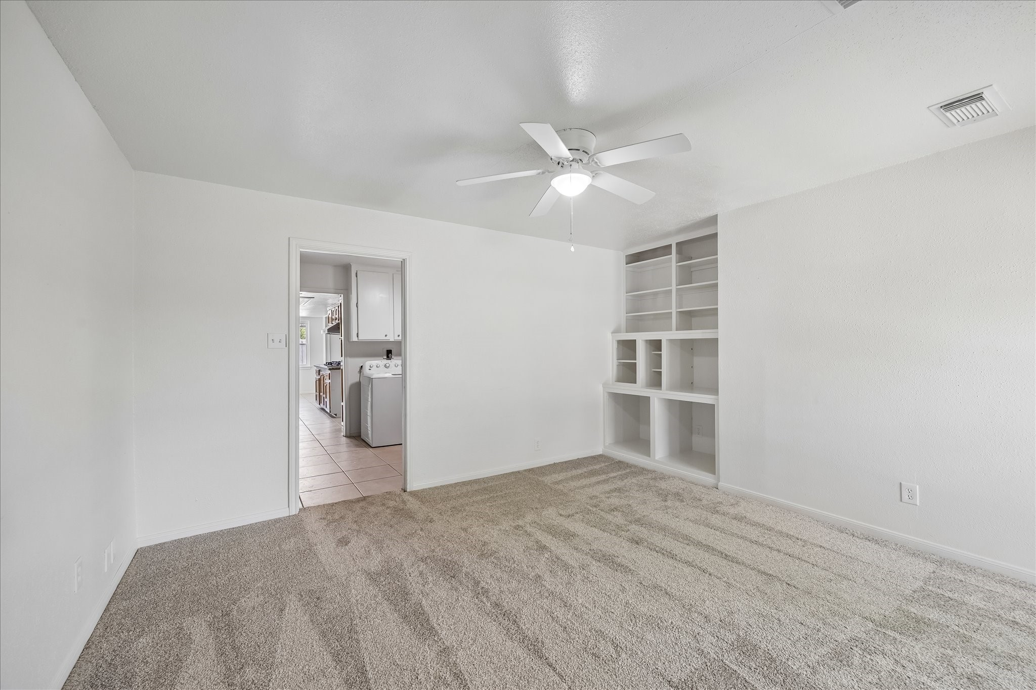 631 Lexington Square Humble, TX 77338 - Photo 14 of 22 Step into this inviting secondary bedroom, featuring fresh new carpet and a spacious, light-filled ambiance perfect for relaxation.