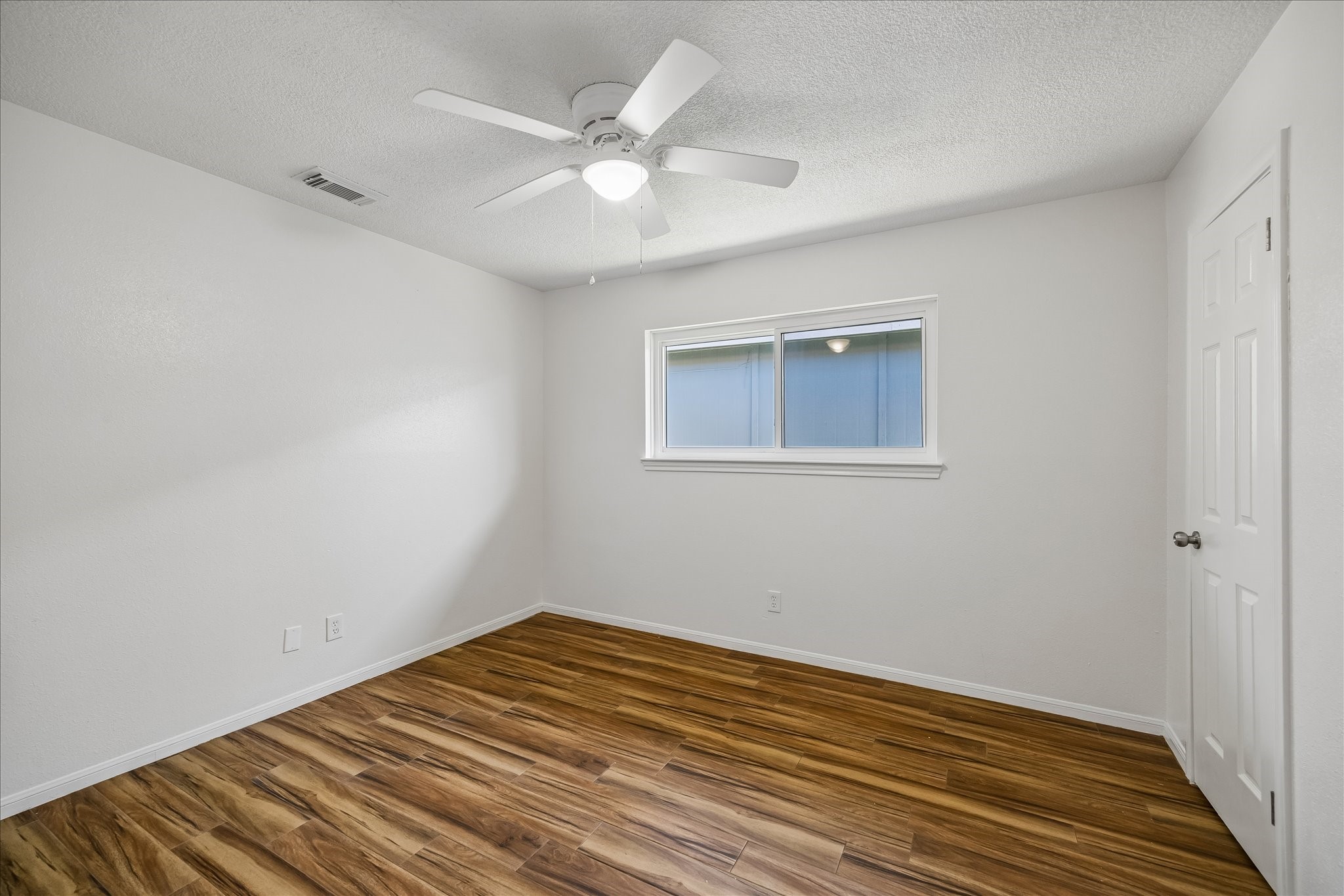 631 Lexington Square Humble, TX 77338 - Photo 15 of 22 This inviting secondary bedroom features elegant wood tile flooring, offering a warm and stylish retreat.