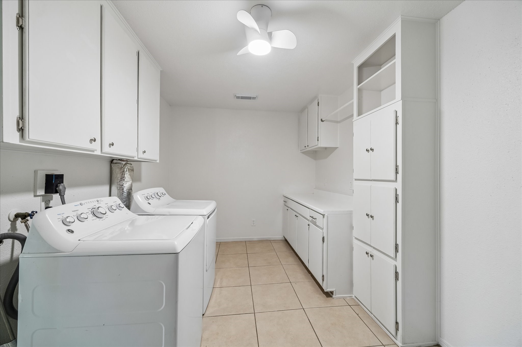 631 Lexington Square Humble, TX 77338 - Photo 20 of 22 Discover the ultimate convenience in this bright, spacious laundry room, featuring ample storage and modern finishes for effortless organization.