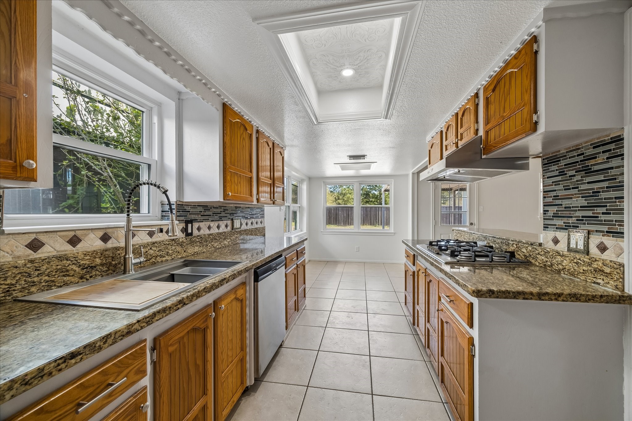 631 Lexington Square Humble, TX 77338 - Photo 3 of 22 Discover a spacious kitchen featuring sleek stainless appliances and elegant granite countertops, perfect for culinary creativity and entertaining.