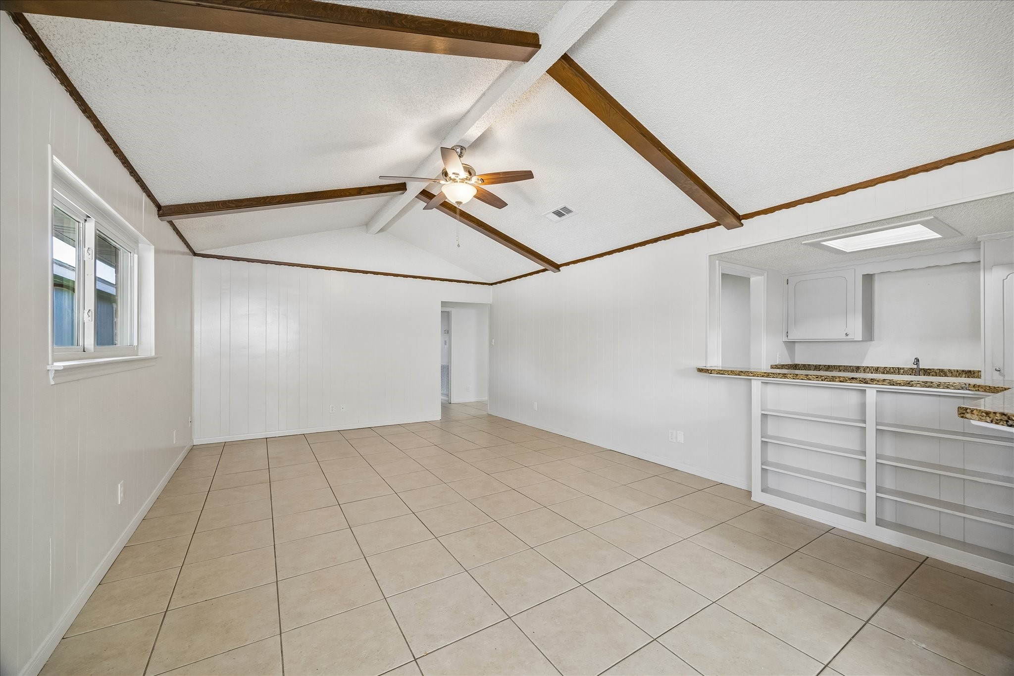 631 Lexington Square Humble, TX 77338 - Photo 8 of 22 Bright and inviting family room featuring an extended bar counter, perfect for entertaining and everyday living.