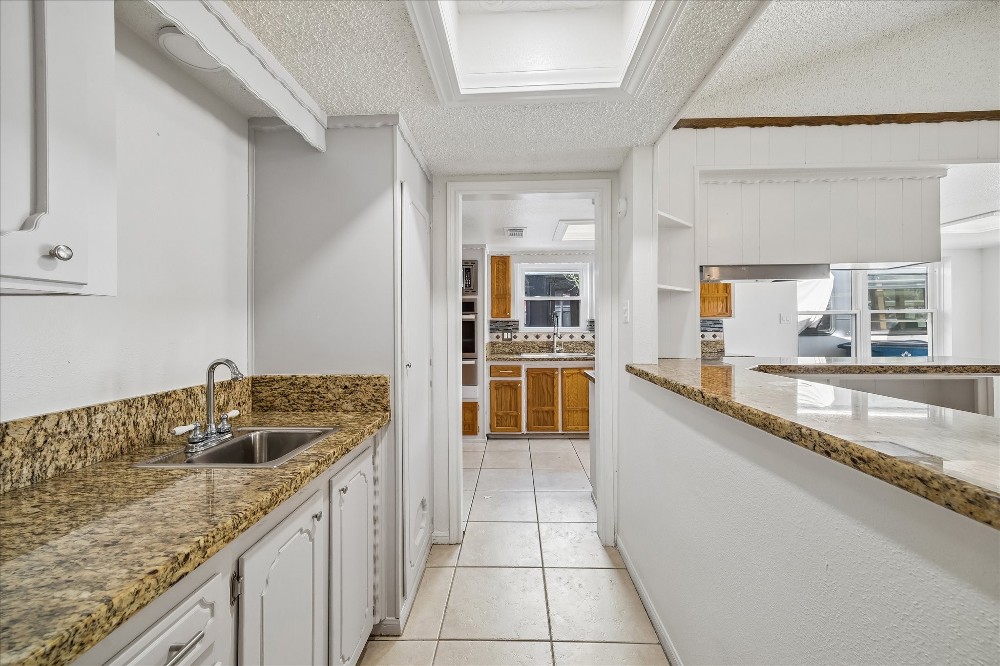 631 Lexington Square Humble, TX 77338 - Photo 10 of 22 Experience seamless living with this inviting breakfast bar connecting the cozy family area and modern kitchen, perfect for entertaining and everyday comfort.