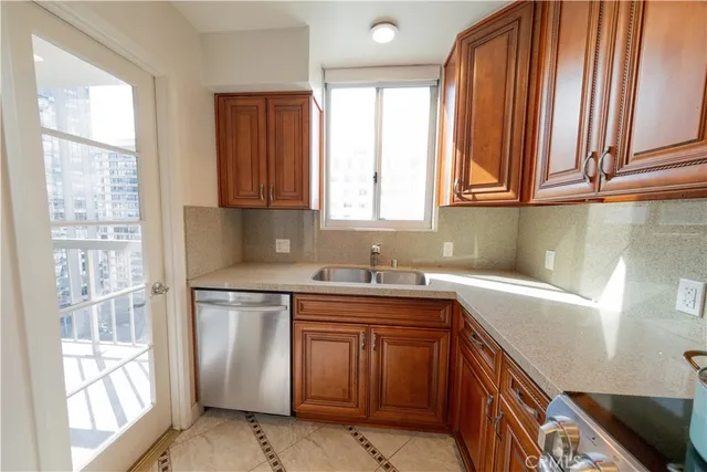 a kitchen with a sink cabinets and a window